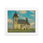 Vintage wall art of a rustic church in a calm countryside with a blue sky, white clouds, green grass, and touches of purple wildflowers. hung on the wall
