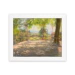 Vintage wall art of a sunny terrace with trees, wooden floor, and distant hills, capturing a peaceful outdoor scene. hung on the wall