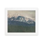 Infidu vintage wall art of snowy mountains in soft blue tones with a misty sky and forested valley. hung on the wall