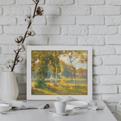 Vintage wall art featuring serene autumn trees with golden-yellow leaves and a calm water background, creating a peaceful natural scene. displayed on the wall in a white frame