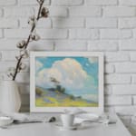 Infidu vintage wall art with blue sky, fluffy white cloud, green hill, and small trees in a peaceful outdoor landscape. displayed on the wall