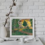 Vintage countryside house with trees and greenery wall art displayed on the wall