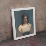 Infidu Vintage Portrait Wall Art of a Thoughtful Woman with soft beige and grey tones, featuring a calm expression and simple background. displayed on the wall