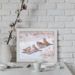 Snowy Birds Vintage Wall Art with small birds sitting on a snowy ground in soft winter tones, bringing a peaceful atmosphere. displayed on the wall