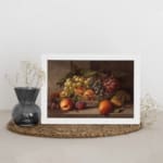 Rustic still-life painting of peaches, grapes, and pears in warm tones with a brown background and white frame. displayed on the wall
