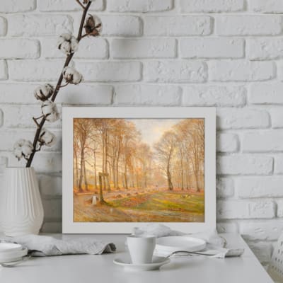 Tranquil woodland winter scene vintage wall art with tall trees and earthy tones. Perfect for rustic and classic interiors. displayed on the wall in a white frame