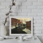 Vintage winter river scene with brick buildings and snowy rooftops by Infidu. displayed on the wall