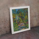 Vintage wall art of a vibrant forest with a colorful flowing stream and expressive brushstrokes. displayed on the wall