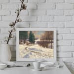 Vintage wall art of a snow-covered pathway with pine trees and a calm winter landscape, framed in white. displayed on the wall