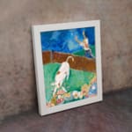 Vintage wall art of a white cow with brown spots in a colorful storybook-style field with flowers, a person, and a blue sky. displayed on the wall
