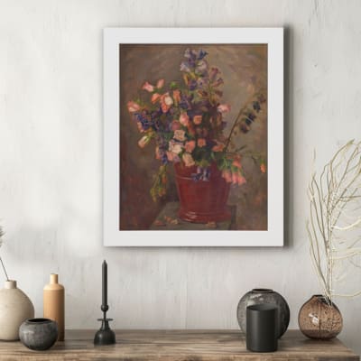 Vintage floral wall art featuring a bouquet in a rustic red pot with soft pink, purple, and green flowers against a dark textured background. hung on the wall in a white frame