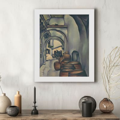 Vintage wall art shows an arched pathway leading to a distant town with muted tones of gray, beige, and brown. hung on the wall in a white frame
