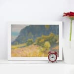 Infidu vintage wall art with a peaceful mountain, a grassy field, and soft natural colors in a calming countryside scene. displayed on the wall