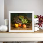 Vintage fruit still life wall art with grapes, apples, peaches, and plums on a rustic surface and dark leafy background. displayed on the wall