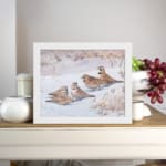 Snowy Birds Vintage Wall Art with small birds sitting on a snowy ground in soft winter tones, bringing a peaceful atmosphere. displayed on the wall