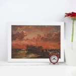Vintage wall art of a wooden ship at sunset with fiery red, orange, and pink sky, calm sea, and small human figures near the shore. displayed on the wall