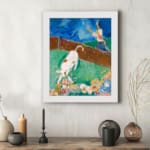 Vintage wall art of a white cow with brown spots in a colorful storybook-style field with flowers, a person, and a blue sky. displayed on the wall