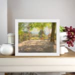 Vintage wall art of a sunny terrace with trees, wooden floor, and distant hills, capturing a peaceful outdoor scene. displayed on the wall
