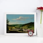 Vintage countryside wall art with hills, houses, and blue sky. displayed on the wall