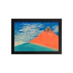 Vintage wall art of Mount Fuji by Hokusai with red mountain, blue sky, and white clouds. hung on the wall