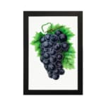 Vintage wall art of dark purple grapes with green leaves on a white background. hung on the wall