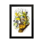 Vintage wall art showing two black and white birds flying near a tree branch with green leaves and bright yellow flowers on a white background. hung on the wall