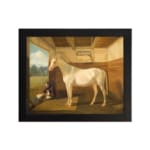 Vintage wall art of a white horse standing calmly inside a rustic wooden stable with a peaceful countryside view. hung on the wall