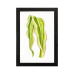 Vintage wall art of a single leaf with flowing, wavy shapes in green and yellow, framed in black on a white background. hung on the wall