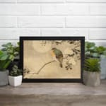 Infidu vintage wall art featuring a delicate bird perched on a branch with small leaves against a soft, neutral background. displayed on the wall art in a black frame