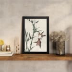 Infidu vintage wall art with two birds flying near bamboo in soft tones. displayed on the wall