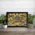 Infidu vintage wall art featuring a majestic dragon in gold, red, and silver tones, surrounded by blue clouds and fiery red flames on a vibrant yellow background. displayed on the wall art in a black frame