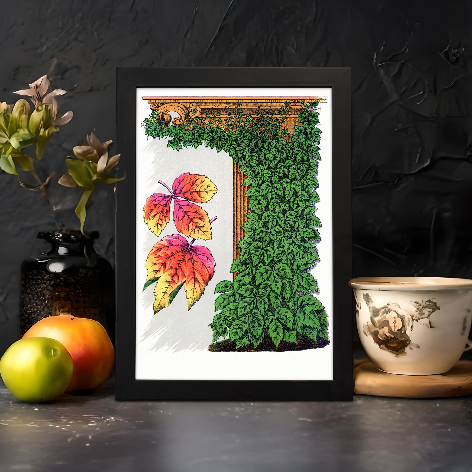 Vintage wall art with colorful red, yellow, and green leaves around a brown wooden frame on a white background, framed in black. displayed on the wall