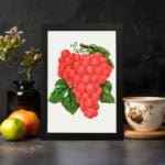 Vintage wall art of red grapes with green leaves on a white background. displayed on the wall