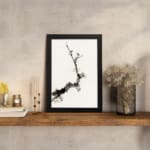 Minimal blossom branch vintage wall art in black and light brown on white background. displayed on the wall