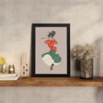 Vintage wall art of a dancing woman in red top and green dress with a beige background, inspired by classic early 1900s poster style. displayed on the wall