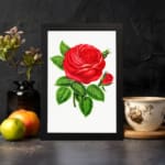 Vintage wall art of a bold red rose with green leaves on a white background, displayed on the wall
