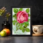 Infidu vintage wall art with a pink rose in full bloom and green leaves on a soft watercolor background. displayed on the wall
