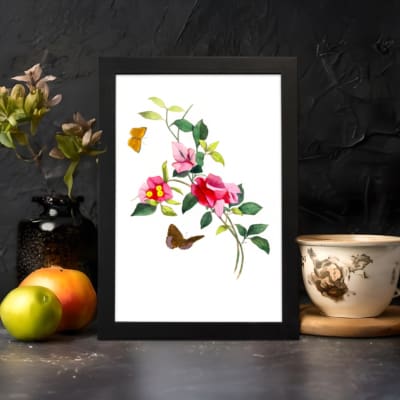 Vintage art of pink and red flowers with green leaves, two orange and brown butterflies, framed in black. displayed on the wall