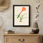 Infidu Elegant Orange Flower Vintage Wall Art featuring a vibrant orange flower with green leaves, framed in black. displayed on the wall