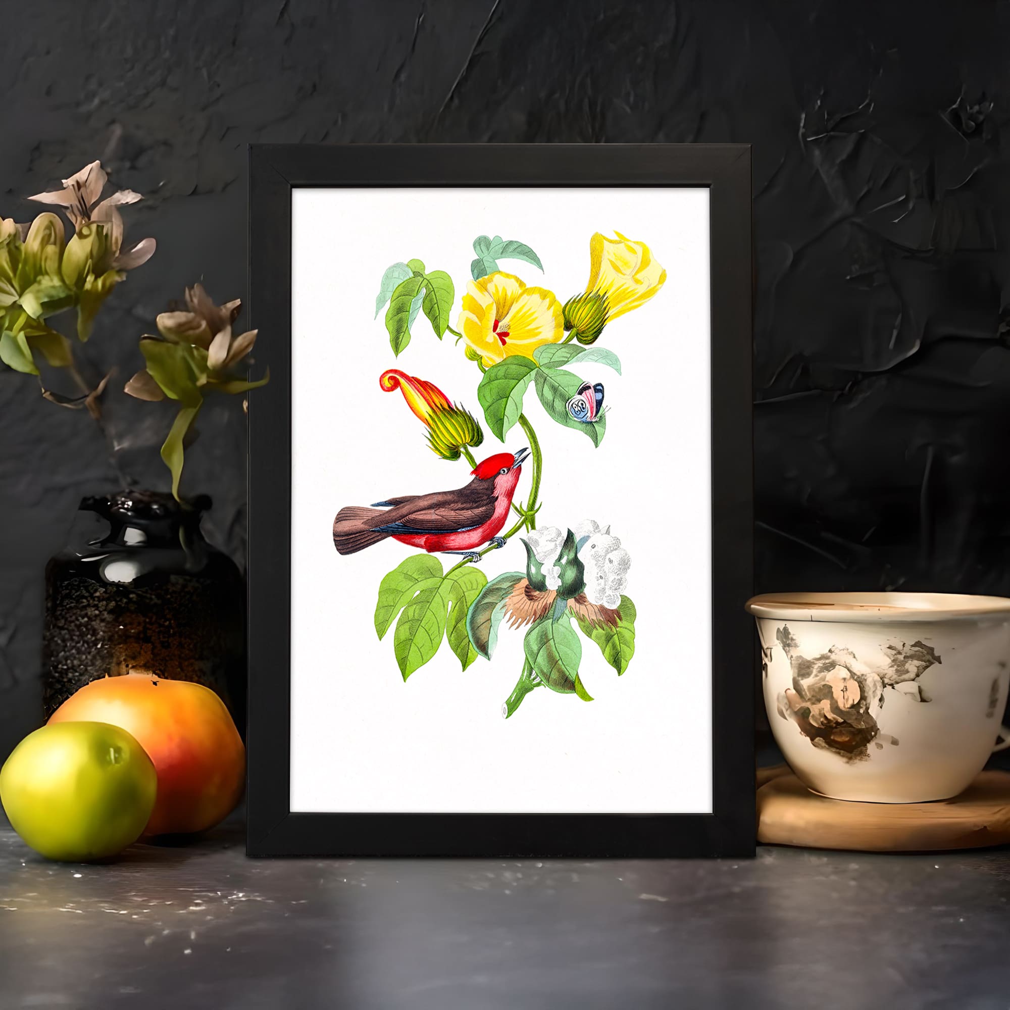 Colorful bird perched on a leafy branch with yellow flowers and cotton bloom, in vintage-style wall art with a white background and black frame. displayed on the wall