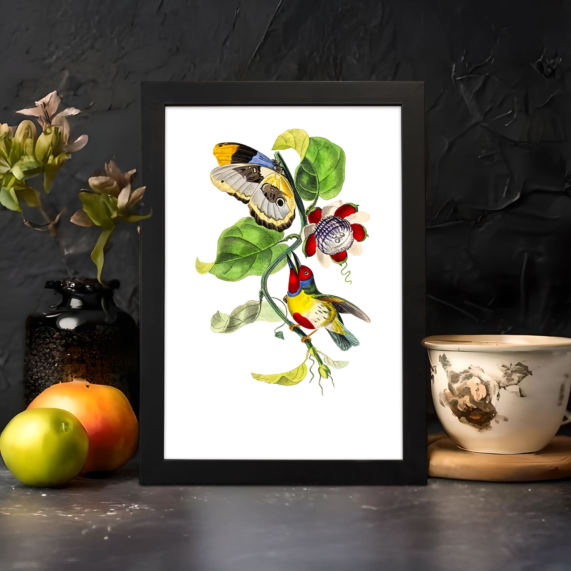 Vintage wall art with two colorful birds perched on a vine with green leaves and a red flower, in a black frame. displayed on the wall