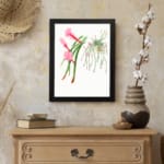 Vintage botanical wall art featuring cactus-like plants and air plants with pink flowers, framed in black for a clean, natural look. displayed on the wall