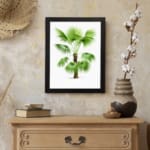 Infidu vintage wall art featuring a small palm tree with green fan-shaped leaves and a textured brown trunk. displayed on the wall
