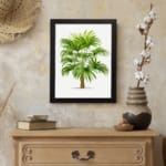 Infidu Vintage Wall Art of a lush tropical plant with green leaves and a brown trunk, framed in black, set against a clean white background. displayed on the wall