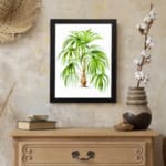 Vintage wall art of a tropical plant with long green leaves and a light brown trunk on a white background with a black frame. displayed on the wall