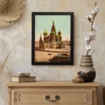 Vintage art print of Saint Basil’s Cathedral with colorful domes, a horse-drawn carriage, and a black frame displayed on the wall