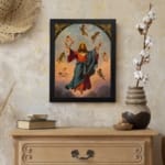 Vintage wall art of Jesus Christ ascending with angels in a soft sky, framed in black with golden accents. displayed on the wall