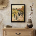 Vintage wall art of people cycling through the countryside with autumn trees and a blue sky, framed in black. displayed on the wall