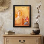 Vintage wall art of an angel and praying woman with glowing light and warm cloudy sky background. displayed on the wall