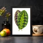 Infidu Vibrant Green and Purple Leaf Vintage Wall Art featuring bright green and purple leaves with natural detailed patterns. displayed on the wall